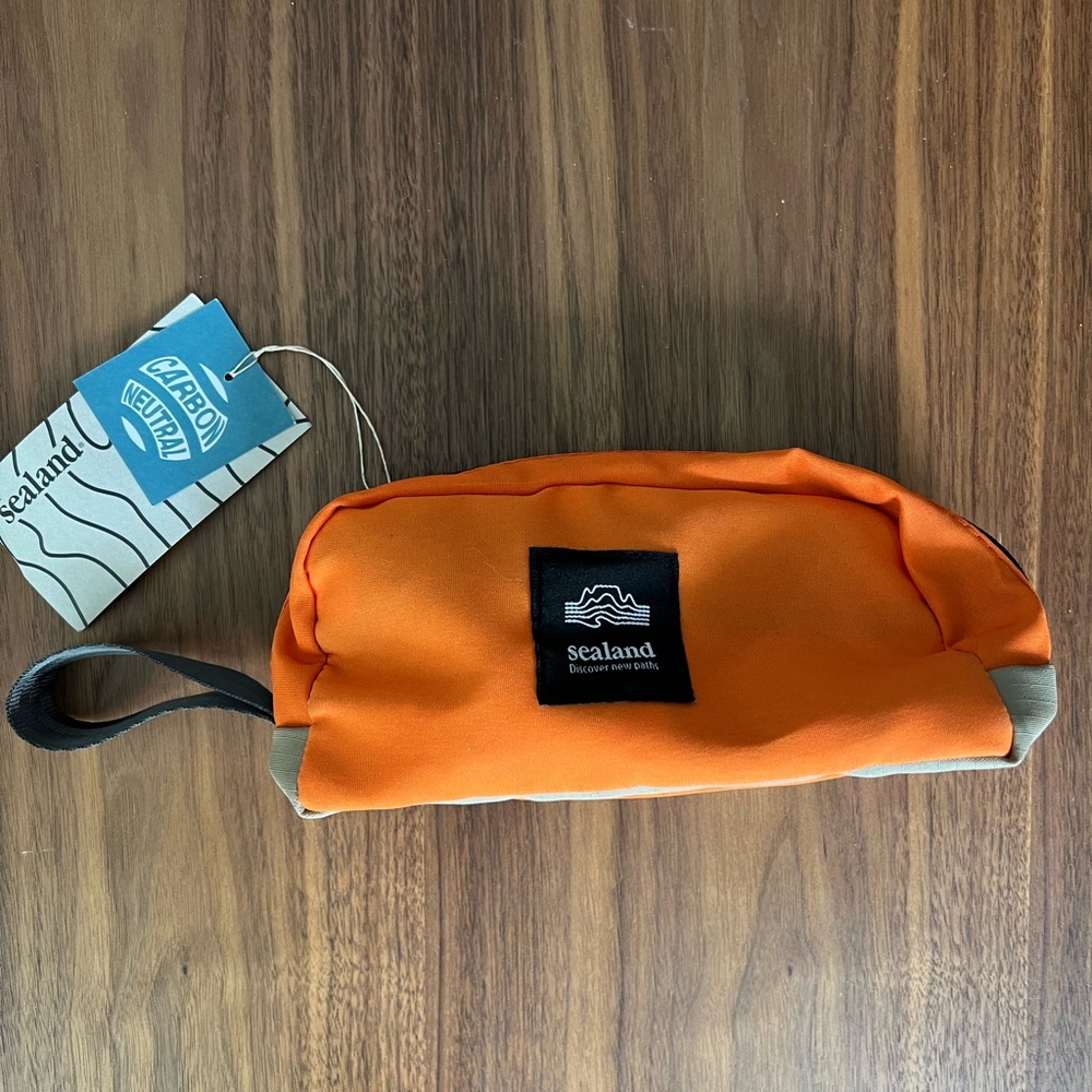 BRAND NEW Sealand Gear storage / toiletries bag in orange. Size small.